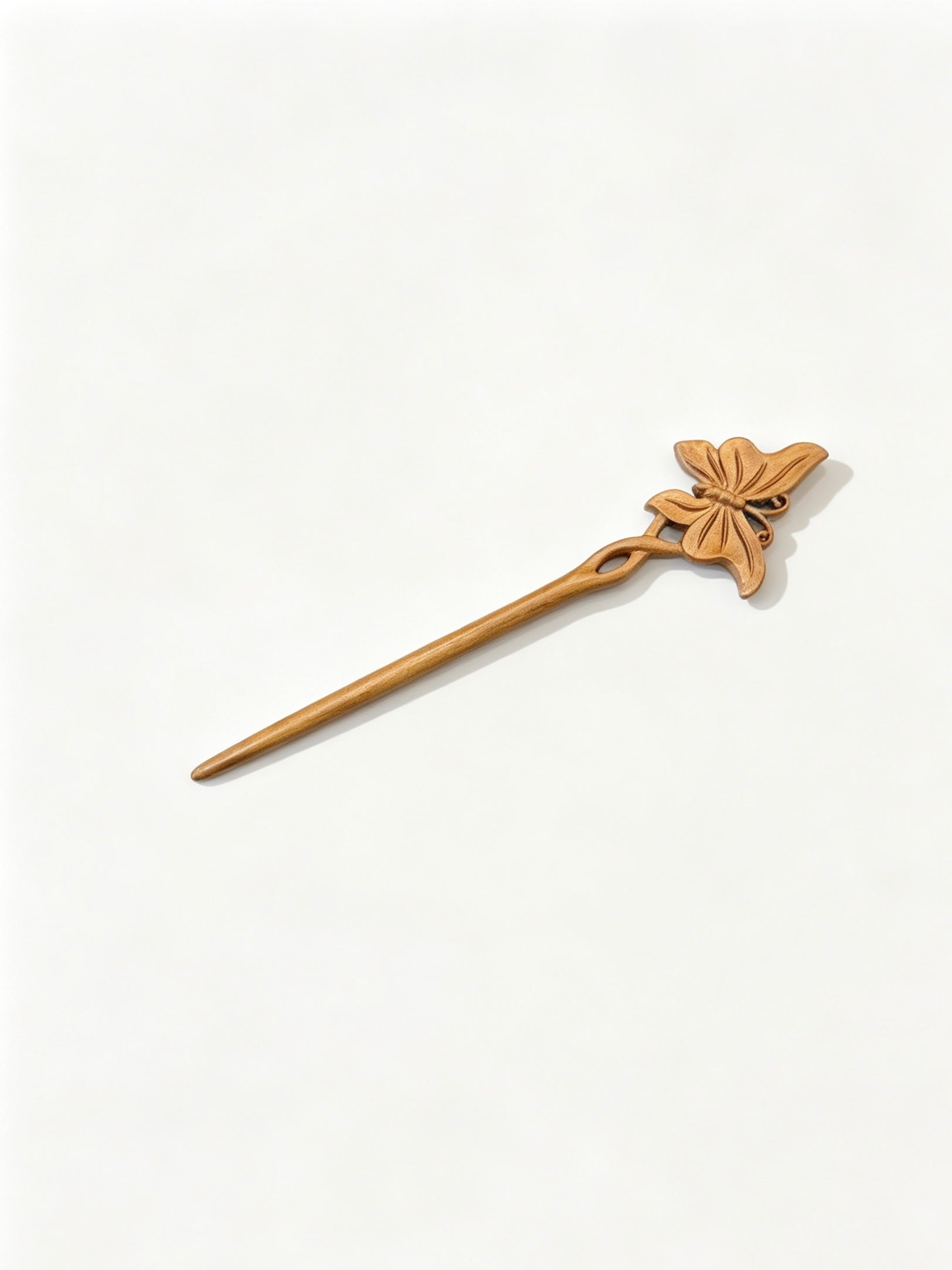 Butterfly carved hair stick displayed on a white background