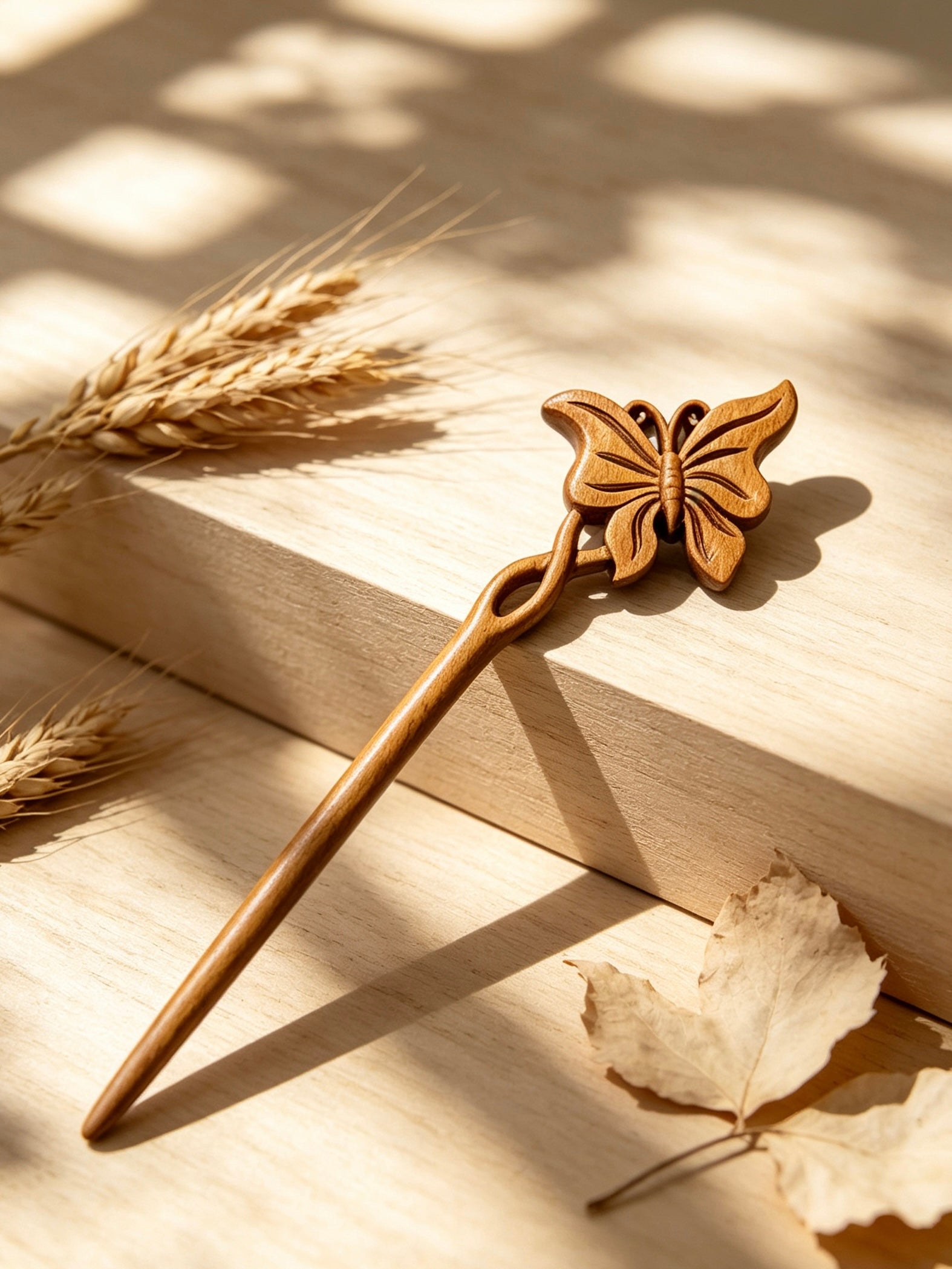 Butterfly carved hair stick displayed on a wooden surface