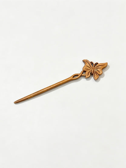 Butterfly carved hair stick displayed on a white background