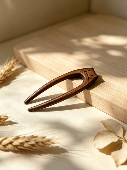 Cat double-prong sandalwood hair fork displayed on a wooden surface