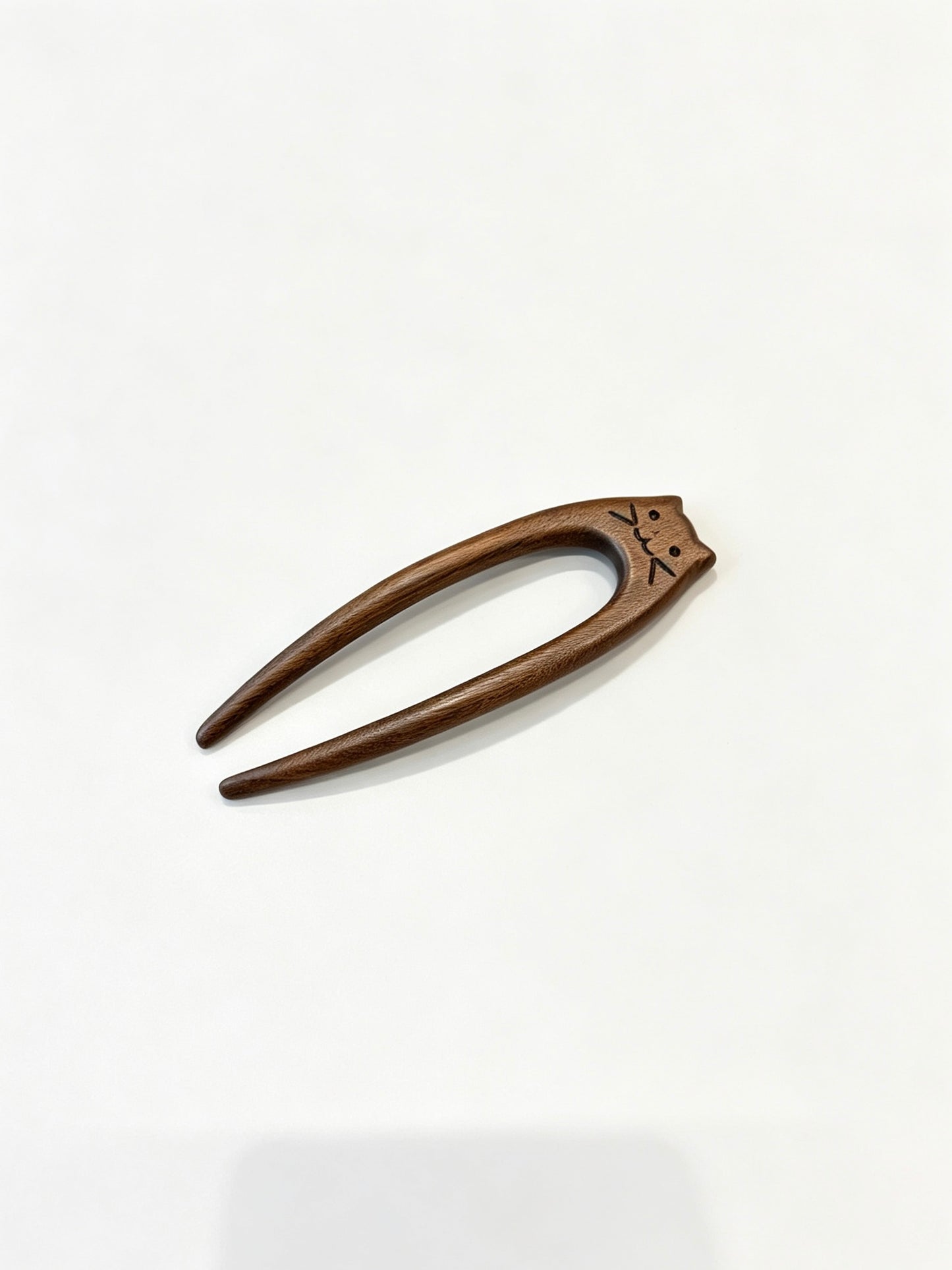 Cat double-prong sandalwood hair fork displayed on a white background