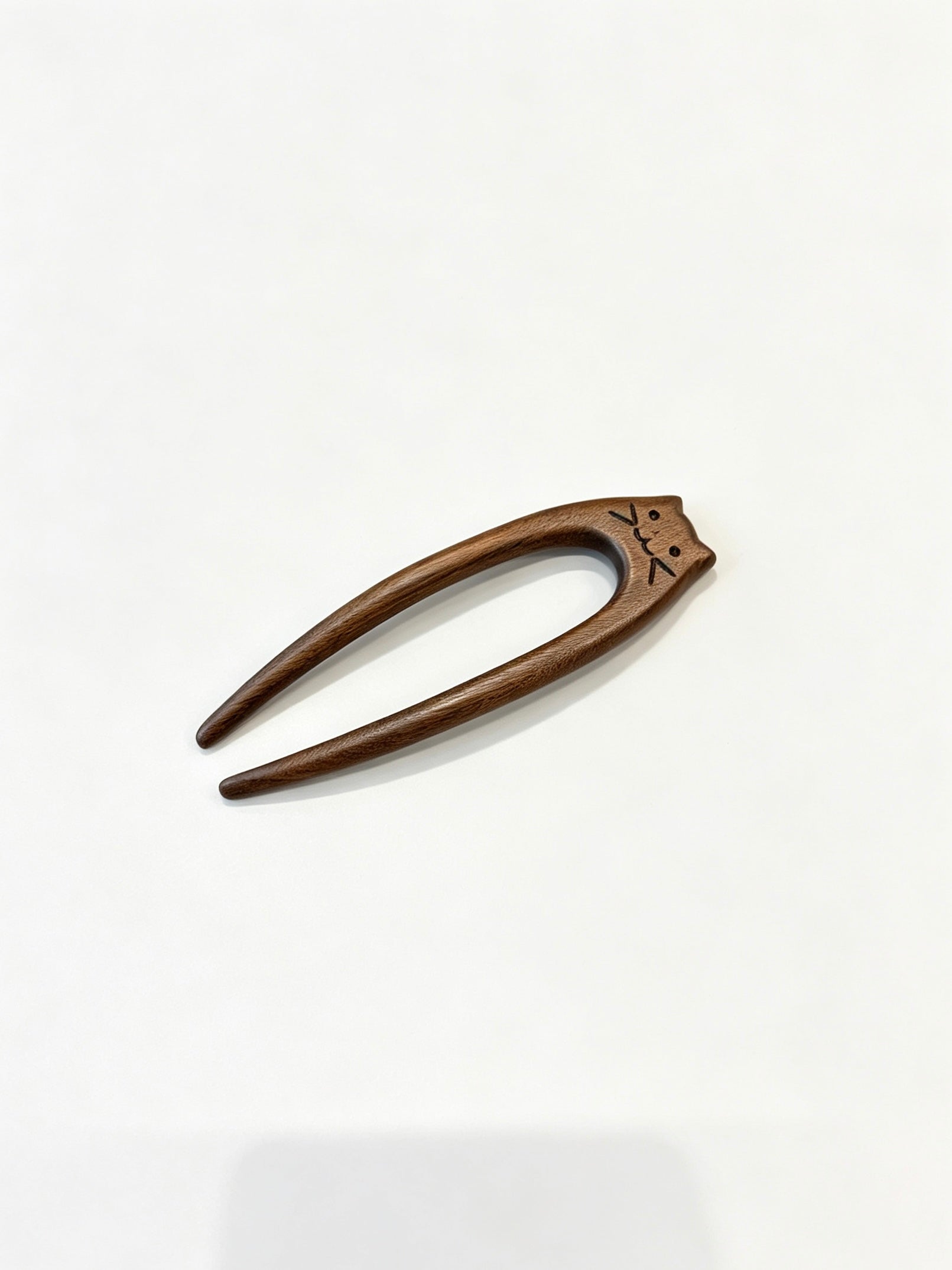 Cat double-prong sandalwood hair fork displayed on a white background