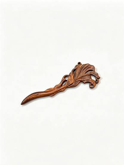Fish carved sandalwood hair stick displayed on a white background