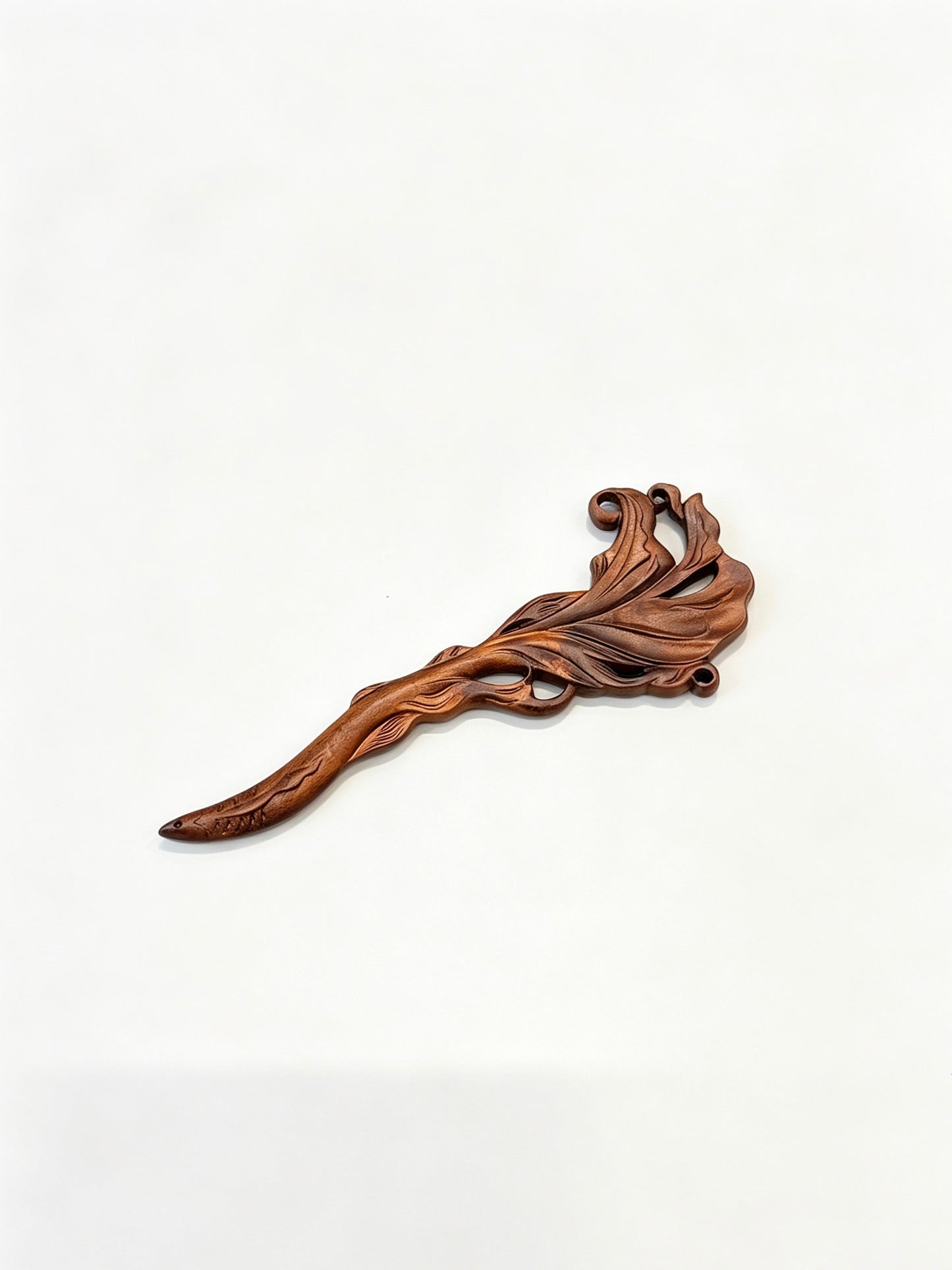 Fish carved sandalwood hair stick displayed on a white background