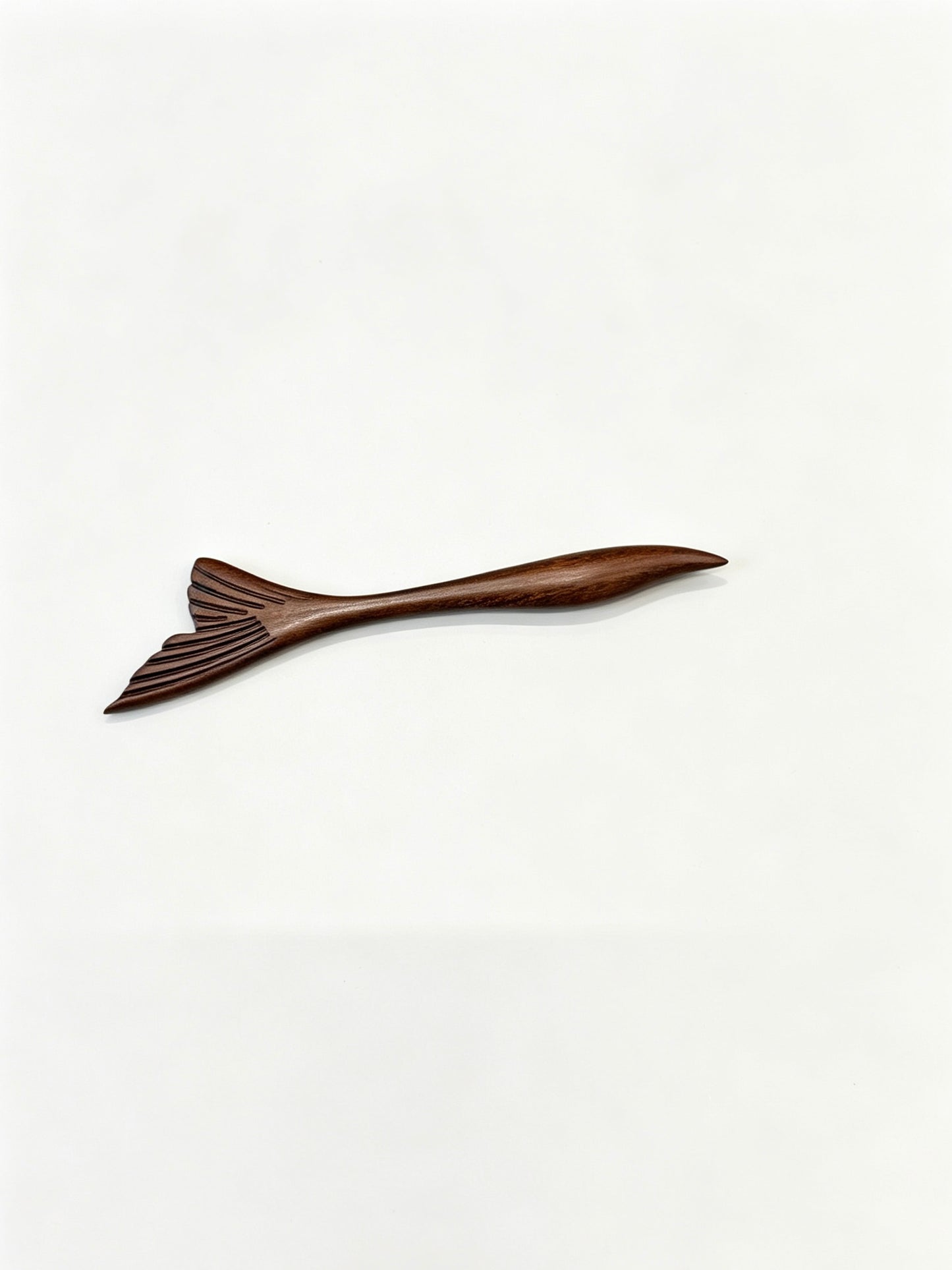 Fish tail sandalwood hair stick displayed on a white background