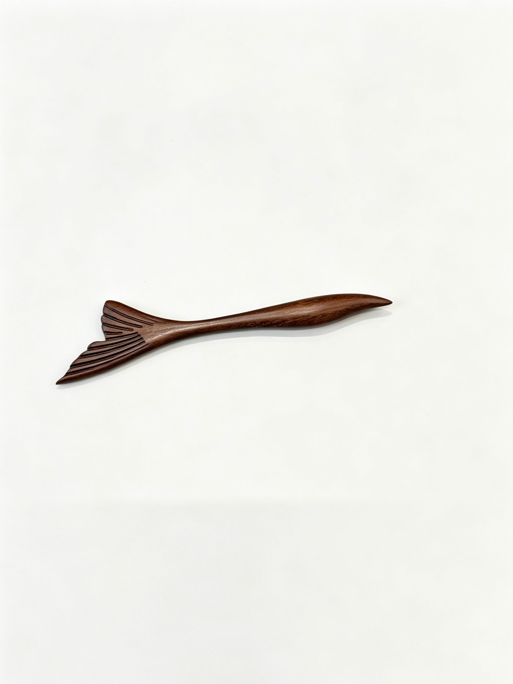 Fish tail sandalwood hair stick displayed on a white background
