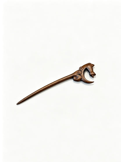 Moon gazing cat sandalwood hair stick displayed on a white background