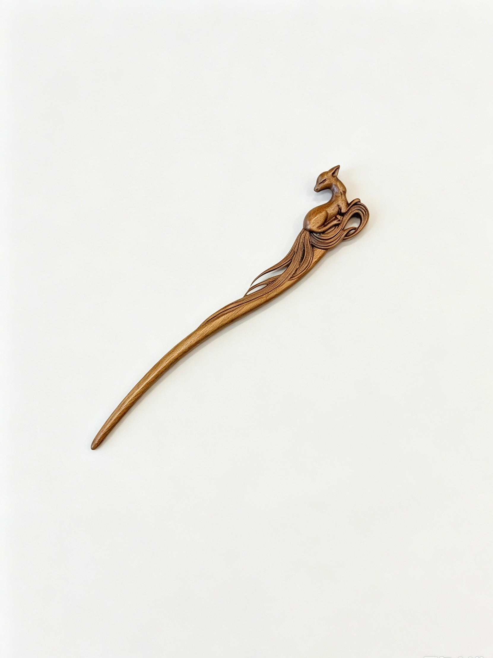 Sandalwood hair stick with a carved deer motif displayed on a white background