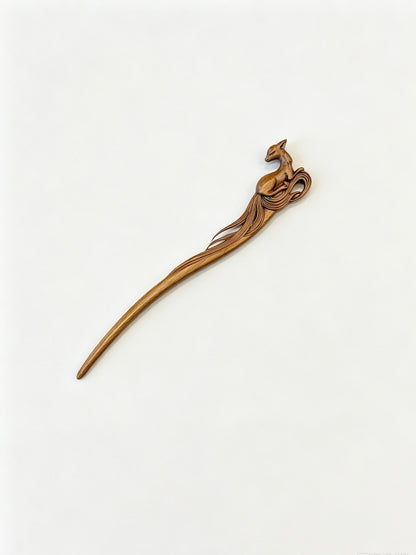 Sandalwood hair stick with a carved deer motif displayed on a white background