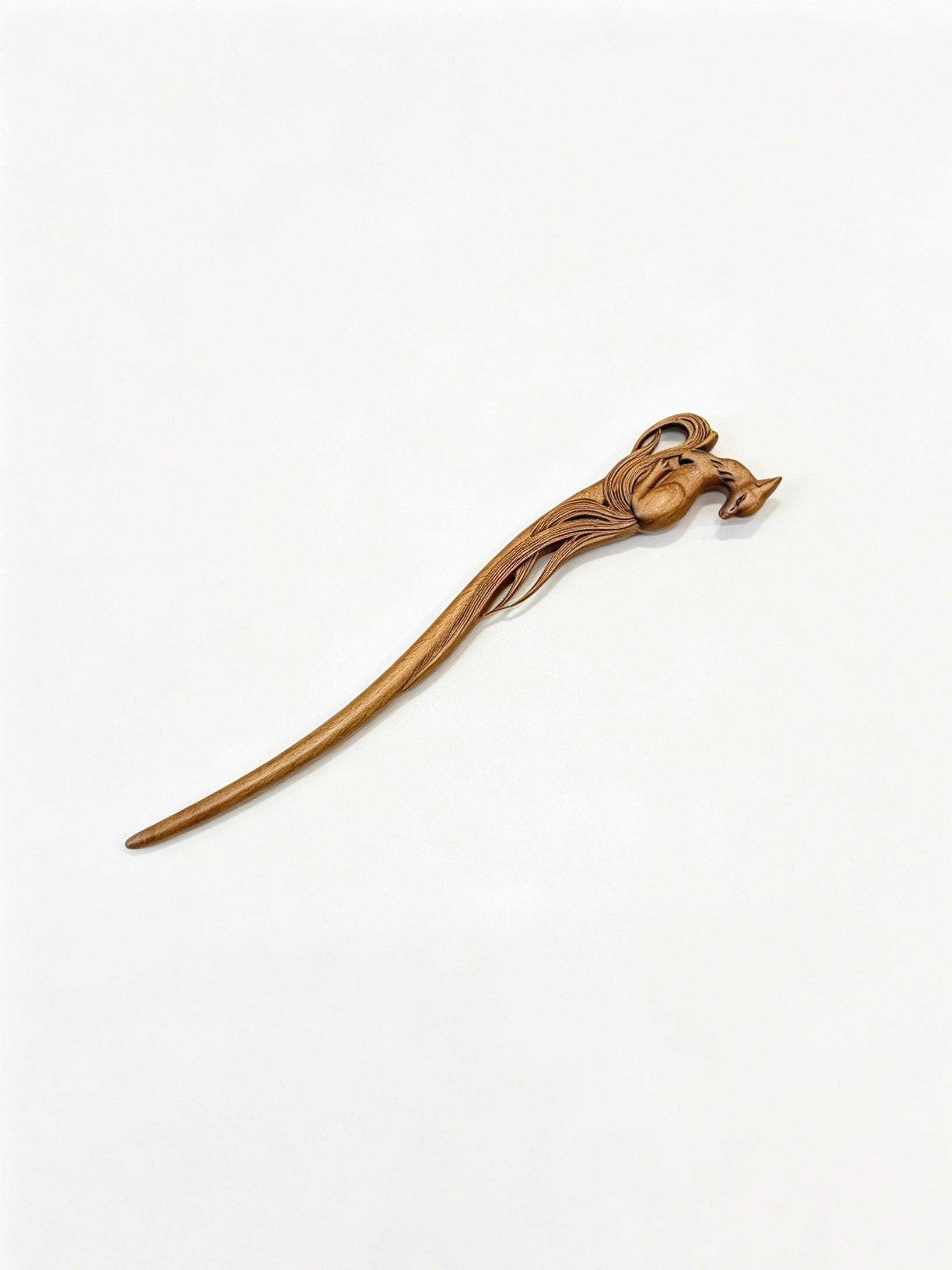 Sandalwood hair stick with a carved deer motif displayed on a white background