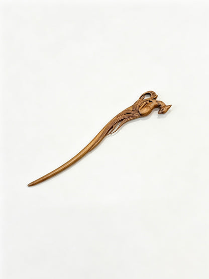 Sandalwood hair stick with a carved deer motif displayed on a white background