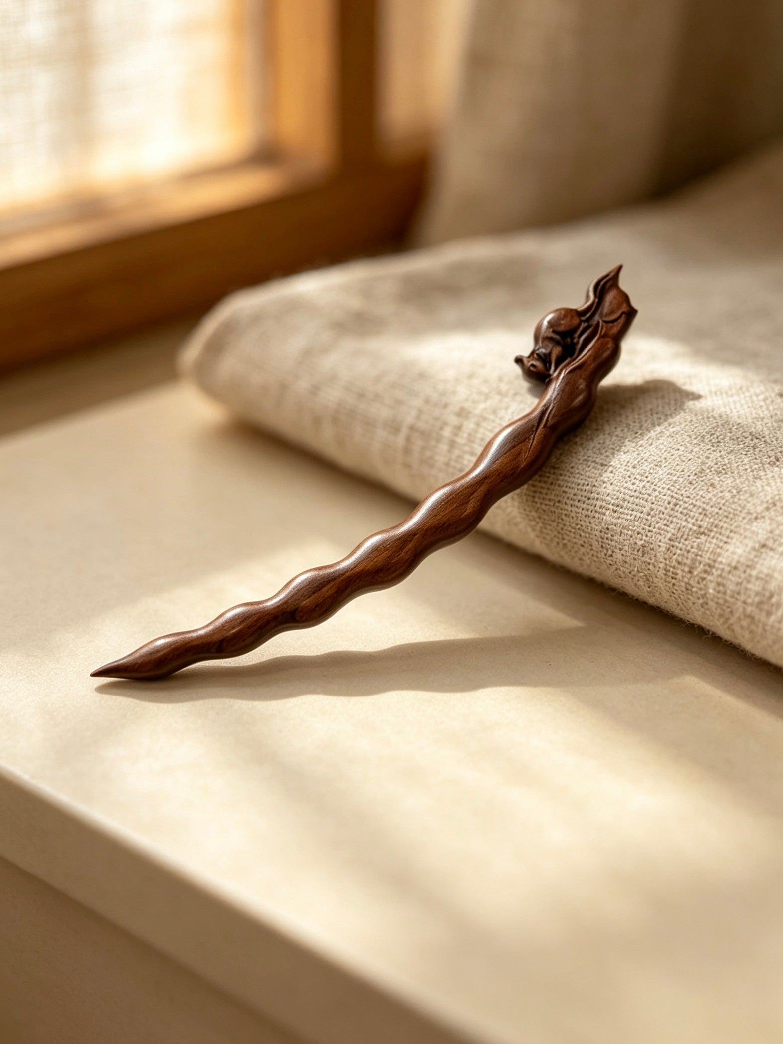 Squirrel peapod sandalwood hair stick displayed on a light surface