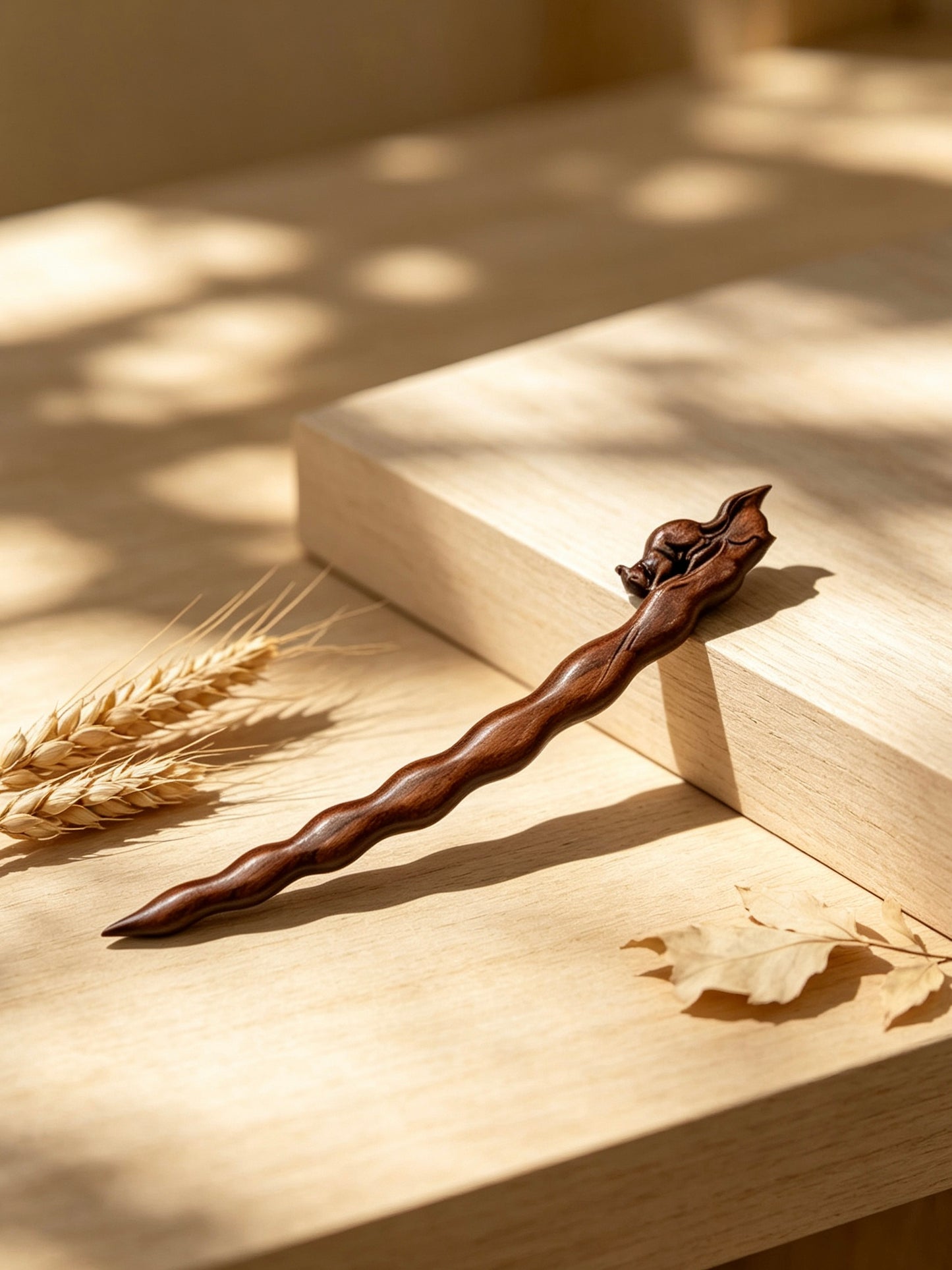 Squirrel peapod sandalwood hair stick displayed on a wooden surface