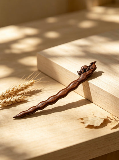 Squirrel peapod sandalwood hair stick displayed on a wooden surface