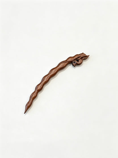 Squirrel peapod sandalwood hair stick displayed on a white background