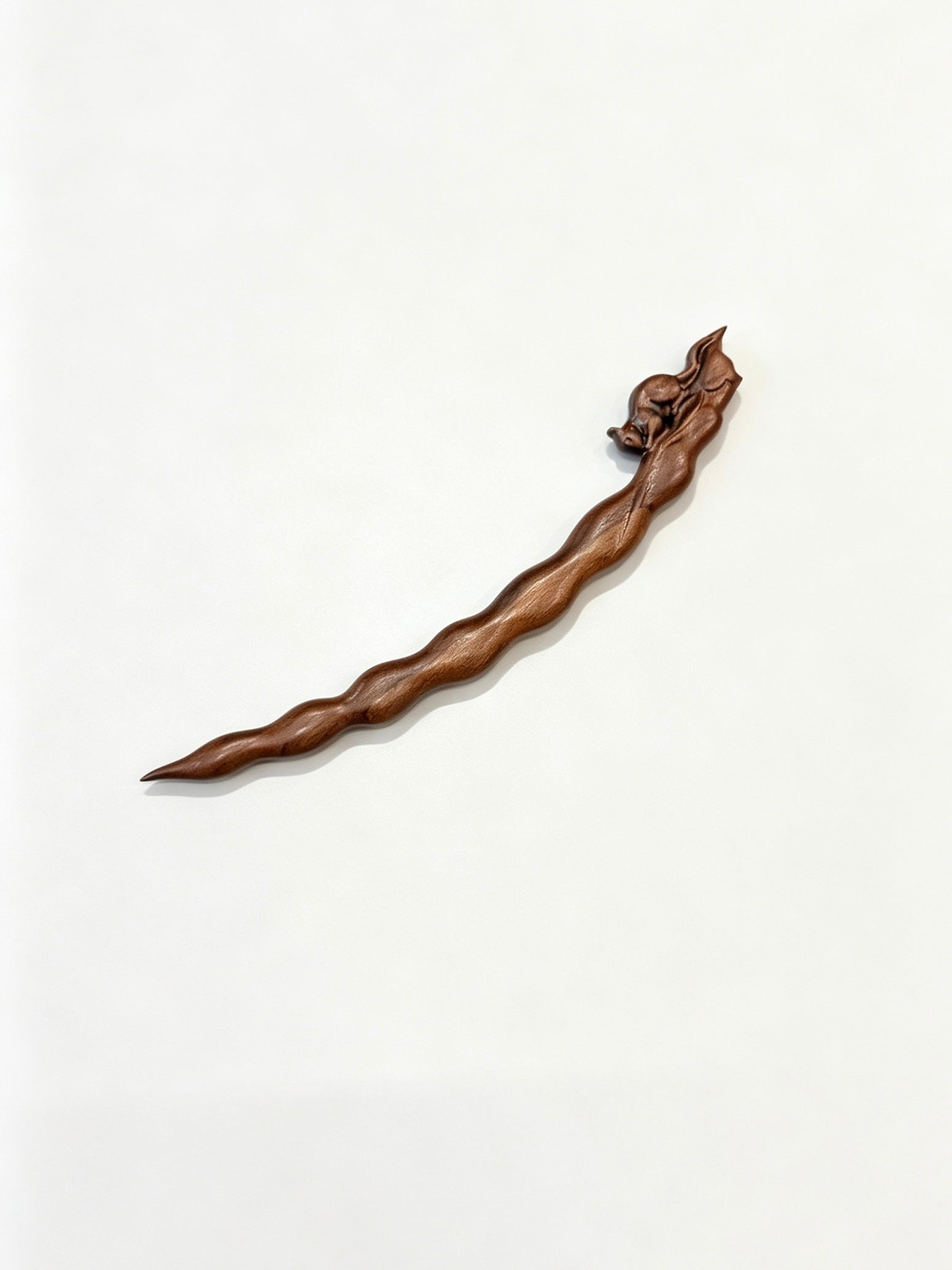 Squirrel peapod sandalwood hair stick displayed on a white background