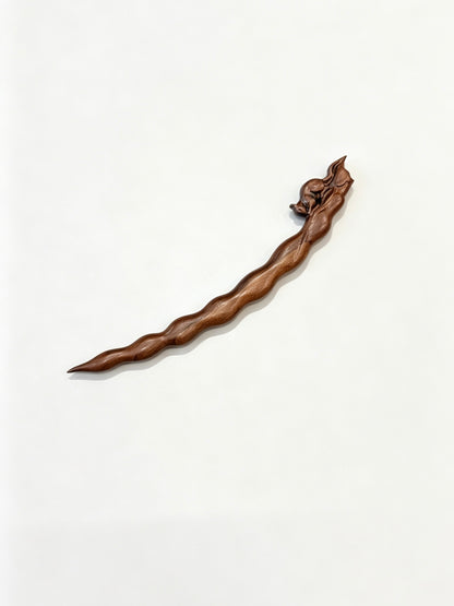 Squirrel peapod sandalwood hair stick displayed on a white background